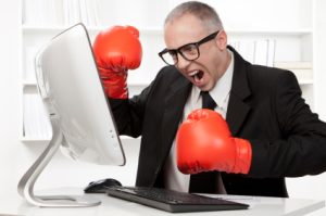 Angry nerd businessman with boxing gloves