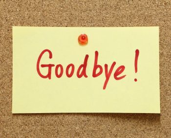 A yellow sticky note pinned to a corkboard with the word "Goodbye!" written in red, like a final message left at a bank teller's window.