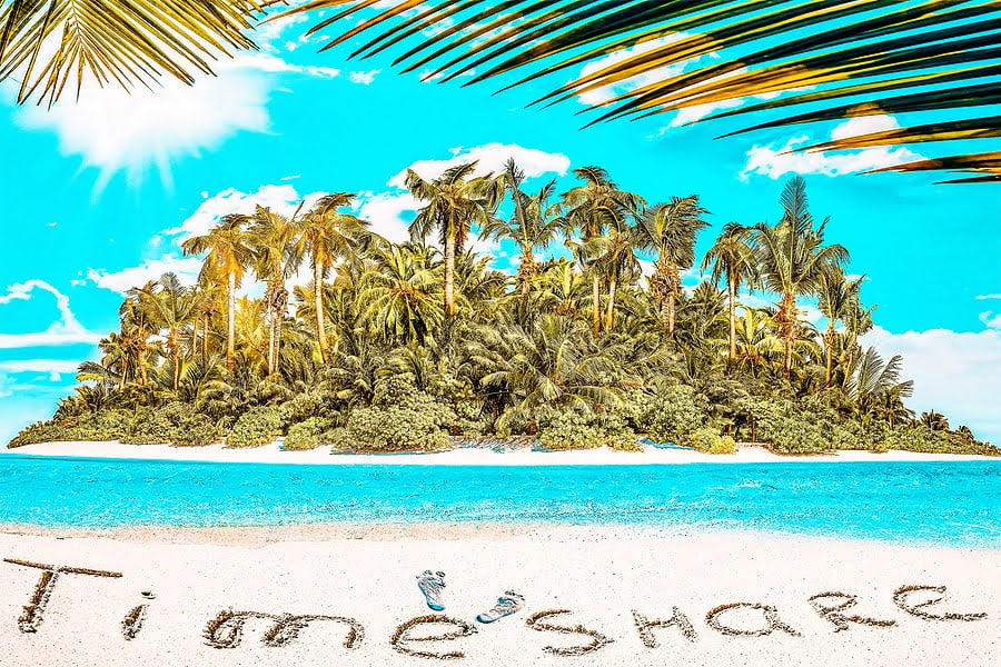 Whole tropical island within atoll in tropical Ocean. Uninhabited and wild subtropical isle with palm trees. Inscription "TimeShare" in the sand on a tropical island, Maldives.