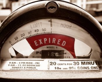 Close-up of an expired parking meter with the dial pointing to "Expired." Text at the bottom of the meter indicates parking rates and hours, reminiscent of a statute of limitations that has quietly run its course.