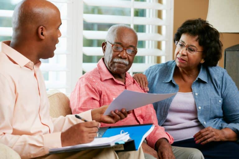 Financial Advisor Talking To Senior Couple At Home