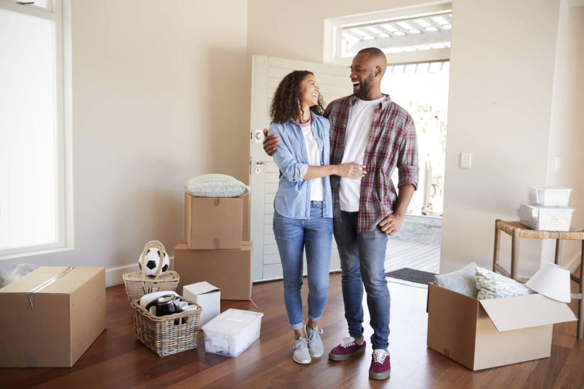 Couple celebrates after buying their first home because they followed a home buying guide