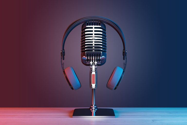 A vintage microphone with a pair of headphones resting on it, placed on a wooden surface, evokes the charm of a bygone era against a striking blue and red gradient background—a timeless setup that needn't require breaking the budget.