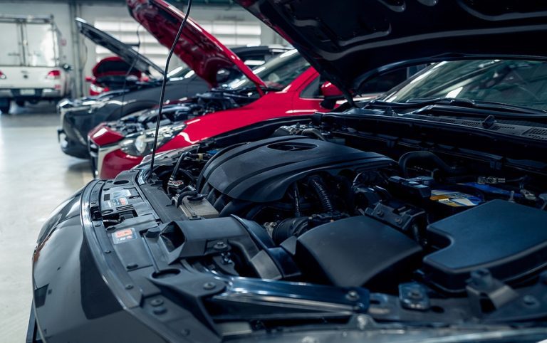 Auto repair shop. Cars open bonnet parked in garage for repair and maintenance service. Car check up at service station. Car waiting for inspection in auto repair shop. Car maintenance and checklist.