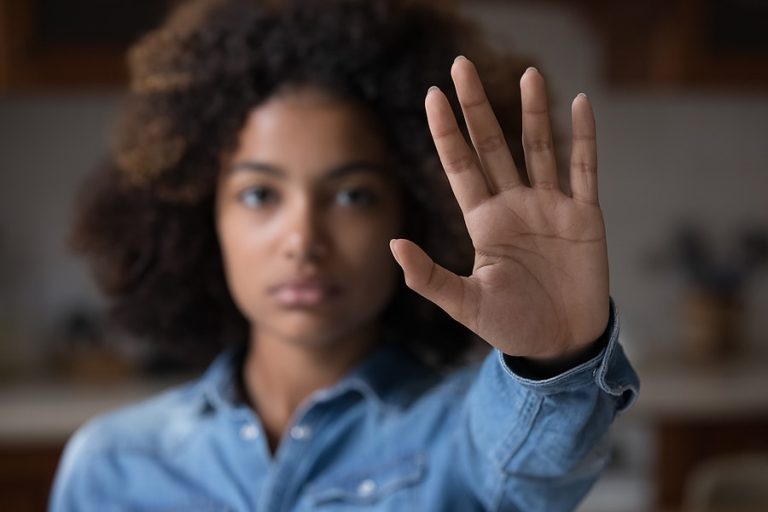 Close up African woman outstretched hand, makes stop gesture