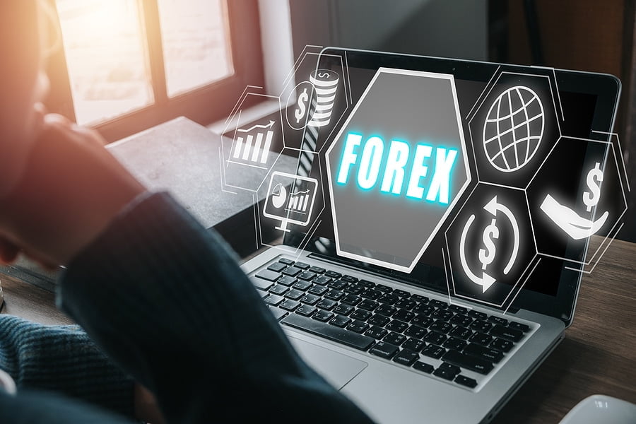 Forex trading, Young man using smartphone and laptop computer with Forex icon on VR screen on desk, Online investment. Business, internet and technology concept.