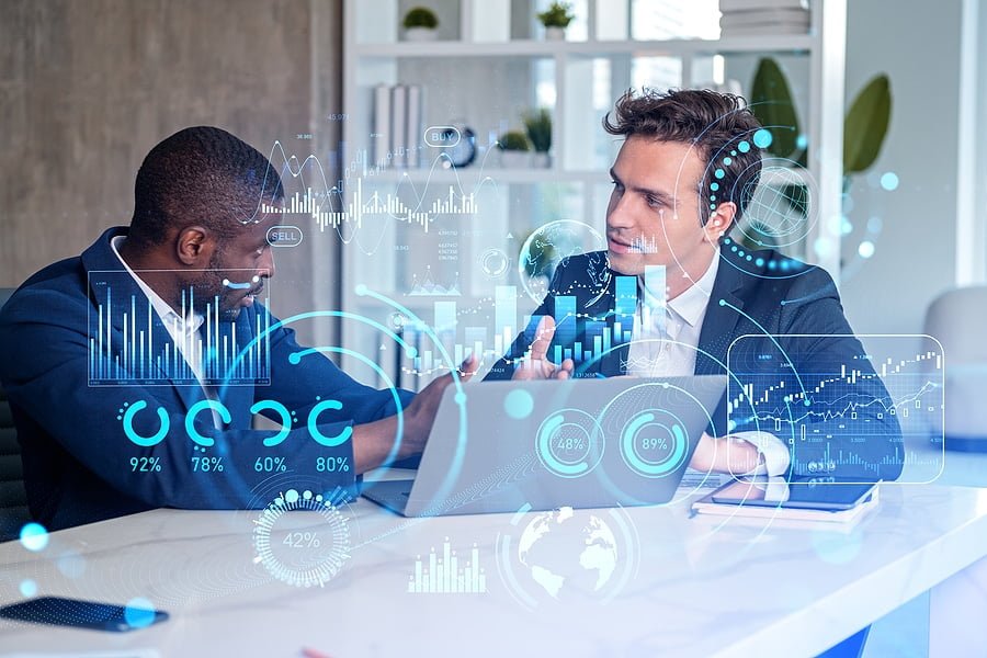 Two businessmen working together, forex diagrams hologram and big business data analysis. Double exposure hologram with candlesticks and chart. Concept of teamwork and trading