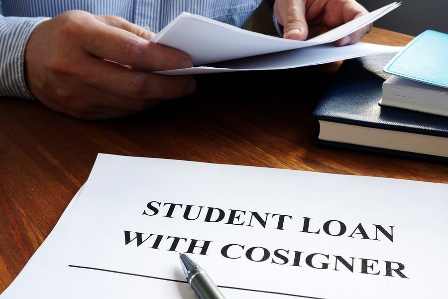 Student loans with cosigner application form and pen.