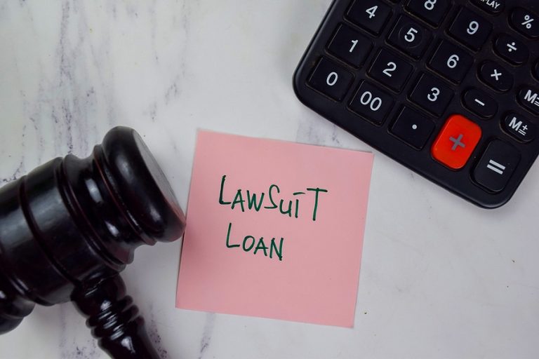 Lawsuit Loan write on sticky notes isolated on Wooden Table. Pre-settlement funding