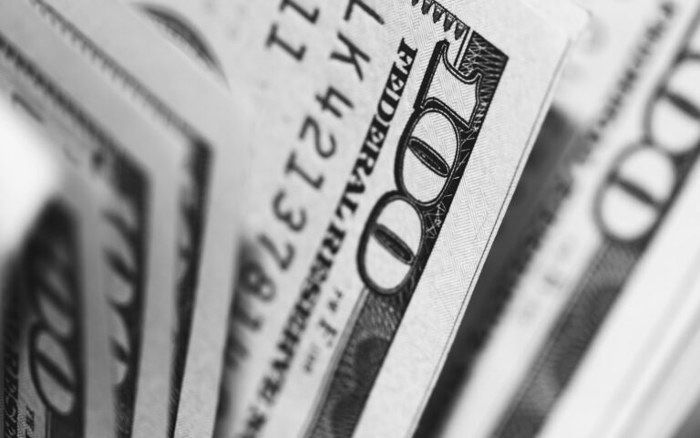 Close-up of fanned-out 100 dollar bills, showing the numbers and part of the design details, a snapshot that beckons any keen financial planner or credit enthusiast to delve into the art of budget mastery.