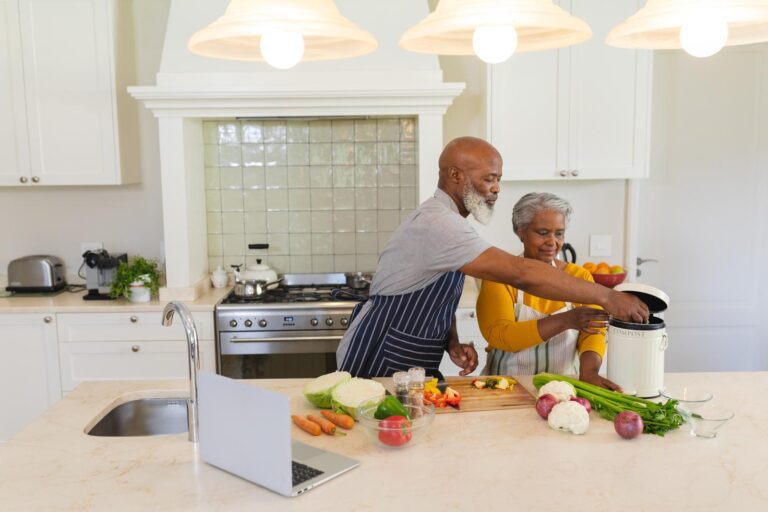 45078188_senior-african-american-couple-cooking-together-in-kitchen