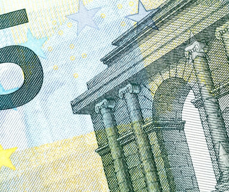 Close-up of a section of a euro banknote, showing part of an architectural design, the number 5, and several stars—offering visual insight useful when understanding your pension plan and its financial details.